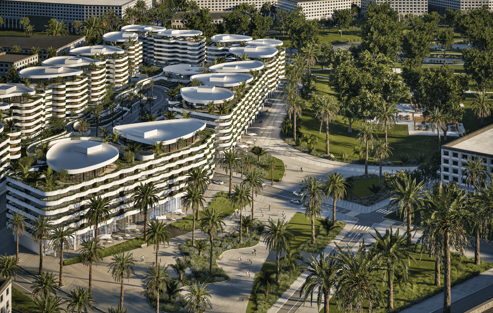Aerial view of modern buildings with rounded rooftops surrounded by palm trees and green park areas.